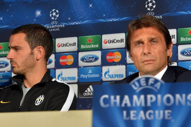 Juventus' defender Leonardo Bonucci (L) and Juventus' coach Antonio Conte attend a press conference on the eve of the Champions League football match between Juventus and  Galatasaray, on October 1, 2013 at the Juventus training centre in Vinovo near Turin. AFP PHOTO / GIUSEPPE CACACE        (Photo credit should read GIUSEPPE CACACE/AFP/Getty Images)