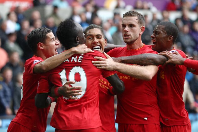 SWANSEA, WALES - OCTOBER 01:  Roberto Firmino of Liverpool celebrates scoring his sides first goal with his team mates during the Premier League match between Swansea City and Liverpool at Liberty Stadium on October 1, 2016 in Swansea, Wales.  (Photo by Julian Finney/Getty Images)