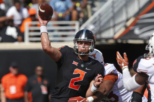 Oklahoma State quarterback Mason Rudolph (2) throws as he is hit by Texas defensive tackle Paul Boyette Jr. (93) in the first quarter of an NCAA college football game in Stillwater, Okla., Saturday, Oct. 1, 2016. (AP Photo/Sue Ogrocki)