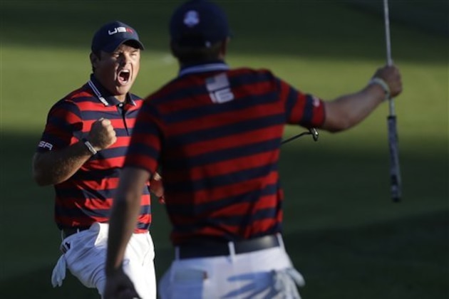 United States’ Patrick Reed reacts with teammate United States’ Jordan Spieth as he makes his put to win the match on the 15th hole during a four-ball match at the Ryder Cup golf tournament Saturday, Oct. 1, 2016, at Hazeltine National Golf Club in Chaska, Minn. (AP Photo/Chris Carlson)