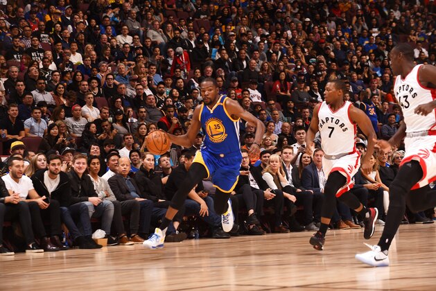 VANCOUVER, BC - OCTOBER 1:  Kevin Durant #35 of the Golden State Warriors drives to the basket against Kyle Lowry #7 of the Toronto Raptors during a preseason game on October 1, 2016 at Rogers Arena in Vancouver, British Columbia, Canada. NOTE TO USER: User expressly acknowledges and agrees that, by downloading and or using this photograph, user is consenting to the terms and conditions of Getty Images License Agreement. Mandatory Copyright Notice: Copyright 2016 NBAE (Photo by Noah Graham/NBAE via Getty Images)