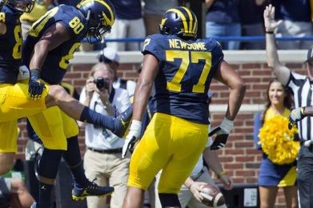 Michigan tight end Jake Butt (88) celebrates his touchdown with fullback Khalid Hill (80) and offensive lineman Grant Newsome (77) during the first quarter of an NCAA college football game against Hawaii at Michigan Stadium in Ann Arbor, Mich., Saturday, Sept. 3, 2016. (AP Photo/Tony Ding)