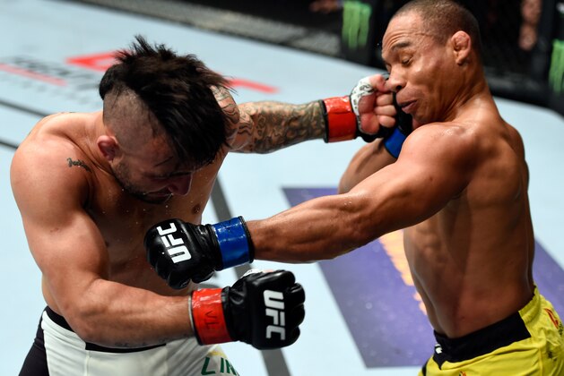 PORTLAND, OR - OCTOBER 01:  (R-L) John Dodson and John Lineker of Brazil exchange punches in their bantamweight bout during the UFC Fight Night event at the Moda Center on October 1, 2016 in Portland, Oregon. (Photo by Josh Hedges/Zuffa LLC/Zuffa LLC via Getty Images)