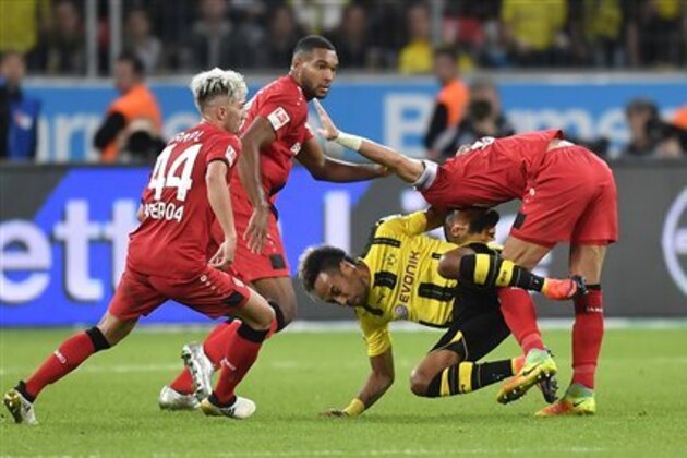 Dortmund's Pierre-Emerick Aubameyang is stopped by three Leverkusen defenders during the German Bundesliga soccer match between Bayer Leverkusen and Borussia Dortmund in Leverkusen, Germany, Saturday, Oct. 1, 2016. (AP Photo/Martin Meissner)