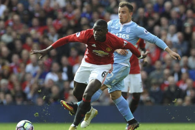 Stoke’s Xherdan Shaqiri, left, and Manchester United’s Paul Pogba battle for the ball during the English Premier League soccer match between Manchester United and Stoke City at Old Trafford in Manchester, England, Sunday, Oct. 2, 2016. (AP Photo/Rui Vieira)
