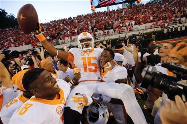 Tennessee wide receiver Jauan Jennings (15) is carried by teammates Kyle Phillips (5) and Charles Mosley (78) after making a last-second touchdown catch to defeat Georgia 34-31 in an NCAA college football game Saturday, Oct. 1, 2016, in Athens, Ga. (AP Photo/John Bazemore)