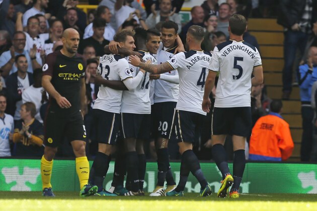 Tottenham's players celebrate taking the lead after Manchester City's Serbian defender Aleksandar Kolarov's own goal during the English Premier League football match between Tottenham Hotspur and Manchester City at White Hart Lane in London, on October 2, 2016. / AFP / IKIMAGES / Ian KINGTON / RESTRICTED TO EDITORIAL USE. No use with unauthorized audio, video, data, fixture lists, club/league logos or 'live' services. Online in-match use limited to 75 images, no video emulation. No use in betting, games or single club/league/player publications.  /         (Photo credit should read IAN KINGTON/AFP/Getty Images)