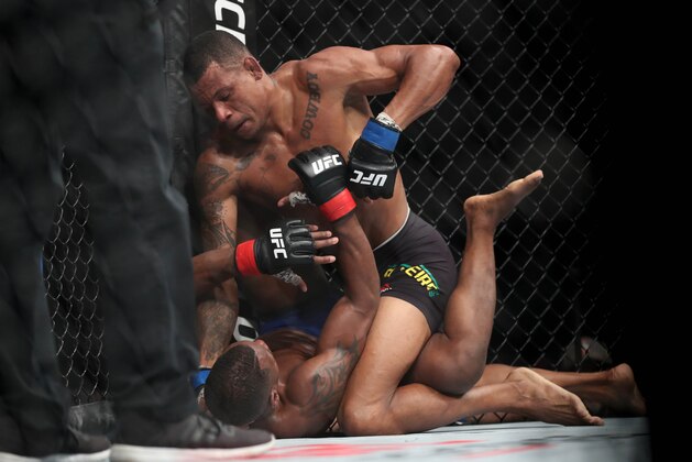 Oct 1, 2016; Portland, OR, USA; Will Brooks (red gloves) fights against Alex Oliveira (blue gloves) during UFC Fight Night at Moda Center. Mandatory Credit: Jaime Valdez-USA TODAY Sports
