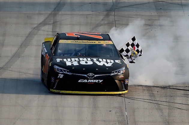 DOVER, DE - OCTOBER 02:  Martin Truex Jr., driver of the #78 Furniture Row/Denver Mattress Toyota, celebrates with the checkered flag after winning the NASCAR Sprint Cup Series Citizen Solider 400 at Dover International Speedway on October 2, 2016 in Dover, Delaware.  (Photo by Brian Lawdermilk/Getty Images)