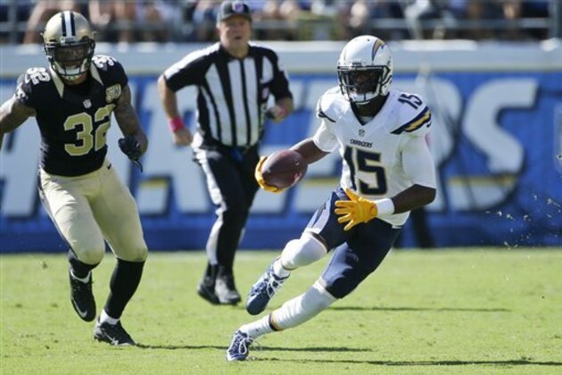San Diego Chargers wide receiver Dontrelle Inman runs with the ball as New Orleans Saints strong safety Kenny Vaccaro (32) defends during the first half of an NFL football game Sunday, Oct. 2, 2016, in San Diego. (AP Photo/Lenny Ignelzi)