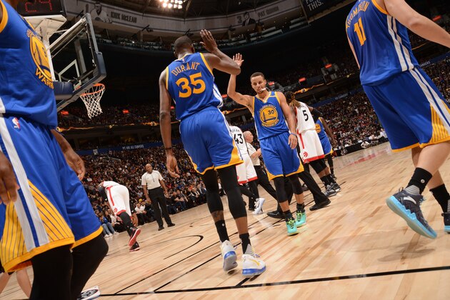 VANCOUVER, BC - OCTOBER 1:  Stephen Curry #30 of the Golden State Warriors high fives Kevin Durant #35 during the game against the Toronto Raptors during a preseason game on October 1, 2016 at Rogers Arena in Vancouver, British Columbia, Canada. NOTE TO USER: User expressly acknowledges and agrees that, by downloading and or using this photograph, user is consenting to the terms and conditions of Getty Images License Agreement. Mandatory Copyright Notice: Copyright 2016 NBAE (Photo by Noah Graham/NBAE via Getty Images)