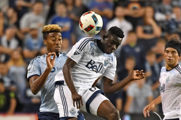 KANSAS CITY, KS - AUGUST 20:  Defender Alphonso Davies #67 of the Vancouver Whitecaps FC heads the ball against defender Saad Abdul-Salaam #17 of Sporting Kansas City during the second half on August 20, 2016 at Children's Mercy Park in Kansas City, Kansas.  (Photo by Peter G. Aiken/Getty Images)