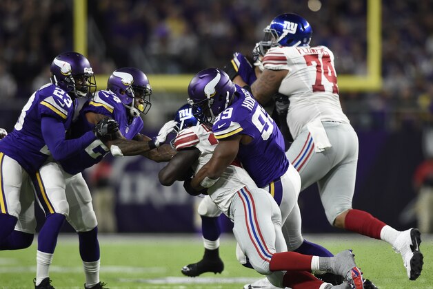 MINNEAPOLIS, MN - OCTOBER 3: Danielle Hunter #99 of the Minnesota Vikings tackles ball carrier Orleans Darkwa #26 of the New York Giants in the second half of the game on October 3, 2016 at US Bank Stadium in Minneapolis, Minnesota. (Photo by Hannah Foslien/Getty Images)