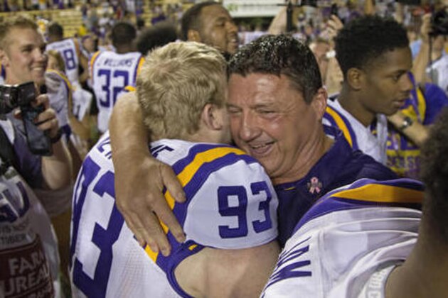 LSU interim coach Ed Orgeron hugs defensive end Seth Newsome (93) during the second half of an NCAA college football game against Missouri in Baton Rouge, La., Saturday, Oct. 1, 2016. LSU won 42-7. (AP Photo/Max Becherer)