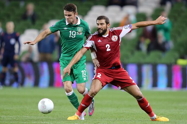 Republic of Ireland's midfielder Robbie Brady vies with Georgia's defender Ucha Lobjanidze (R) during the Euro 2016 qualifying group D football match between Republic of Ireland and Georgia at Aviva Stadium in Dublin on September 7, 2015. AFP PHOTO / PAUL FAITH        (Photo credit should read PAUL FAITH/AFP/Getty Images)
