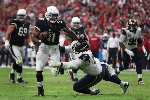 GLENDALE, AZ - OCTOBER 02: Running back David Johnson #31 of the Arizona Cardinals runs with the football after a reception against defensive tackle Michael Brockers #90 of the Los Angeles Rams in the first half of the NFL game at the University of Phoenix Stadium on October 2, 2016 in Glendale, Arizona.  (Photo by Christian Petersen/Getty Images)