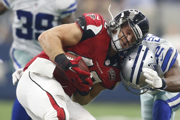 Sep 27, 2015; Arlington, TX, USA; Atlanta Falcons fullback Patrick DiMarco (42) is tackled by Dallas Cowboys strong safety Barry Church (42) in the third quarter at AT&T Stadium. Atlanta won 39-28. Mandatory Credit: Tim Heitman-USA TODAY Sports