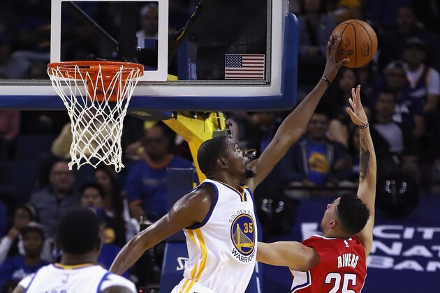 OAKLAND, CA - OCTOBER 04:  Kevin Durant #35 of the Golden State Warriors blocks a shot by Austin Rivers #25 of the Los Angeles Clippers during their preseason game at ORACLE Arena on October 4, 2016 in Oakland, California.  NOTE TO USER: User expressly acknowledges and agrees that, by downloading and or using this photograph, User is consenting to the terms and conditions of the Getty Images License Agreement.  (Photo by Ezra Shaw/Getty Images)