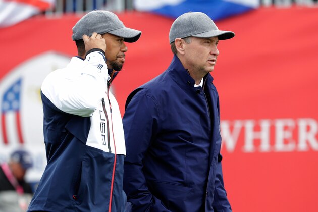 CHASKA, MN - SEPTEMBER 30: Vice-captain Tiger Woods and captain Davis Love III of the United States walk off the first tee during morning foursome matches of the 2016 Ryder Cup at Hazeltine National Golf Club on September 30, 2016 in Chaska, Minnesota.  (Photo by Jamie Squire/Getty Images)