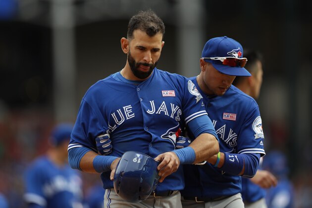 ARLINGTON, TX - MAY 15:  Jose Bautista #19 of the Toronto Blue Jays walks off the field with Ryan Goins #17 after the benches cleared in the eighth inning at Globe Life Park in Arlington on May 15, 2016 in Arlington, Texas.  (Photo by Ronald Martinez/Getty Images)