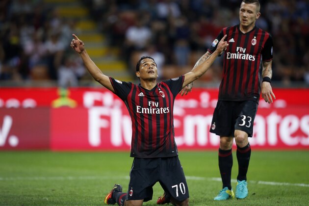AC Milan's forward Carlos Bacca from Colombia (L) celebrates after scoring during the Italian Serie A football match AC Milan vs Sassuolo on October 2, 2016 at the San Siro stadium in Milan.  / AFP / MARCO BERTORELLO        (Photo credit should read MARCO BERTORELLO/AFP/Getty Images)