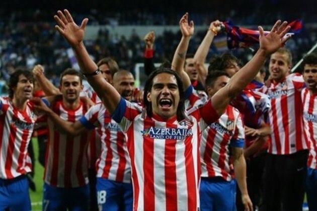 Atletico de Madrid's Radamel Falcao from Colombia, center, and teammates celebrate defeating Real Madrid in the Copa del Rey final soccer match at the Santiago Bernabeu stadium in Madrid, Spain, Friday, May 17, 2013. (AP Photo/Andres Kudacki)