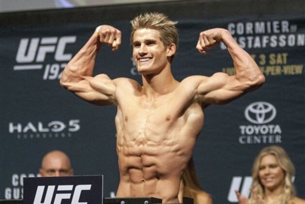 UFC fighter Sage Northcutt flexes his muscles during the weigh in for UFC 192, Friday, Oct. 2, 2015 in Houston. (AP Photo/Juan DeLeon)