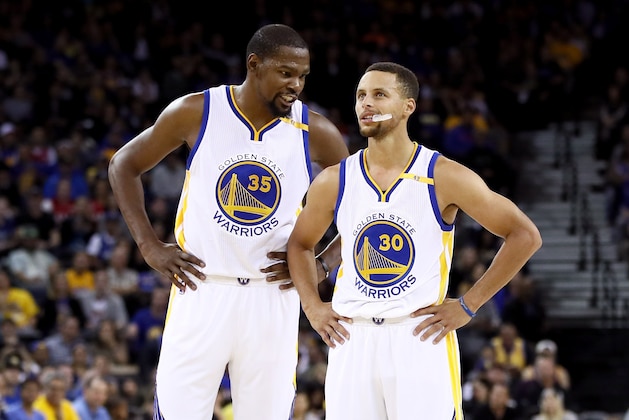 OAKLAND, CA - OCTOBER 04:  Kevin Durant #35 talks to Stephen Curry #30 of the Golden State Warriors during their game against the Los Angeles Clippers during their preseason game at ORACLE Arena on October 4, 2016 in Oakland, California.  NOTE TO USER: User expressly acknowledges and agrees that, by downloading and or using this photograph, User is consenting to the terms and conditions of the Getty Images License Agreement.  (Photo by Ezra Shaw/Getty Images)