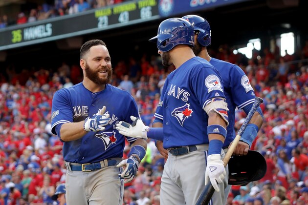 ARLINGTON, TX - OCTOBER 06:  Russell Martin #55 of the Toronto Blue Jays celebrates with his teammates after scoring a run off of Troy Tulowitzki #2 RBI triple to right field against Cole Hamels #35 of the Texas Rangers during the third inning in game one of the American League Divison Series at Globe Life Park in Arlington on October 6, 2016 in Arlington, Texas.  (Photo by Ronald Martinez/Getty Images)