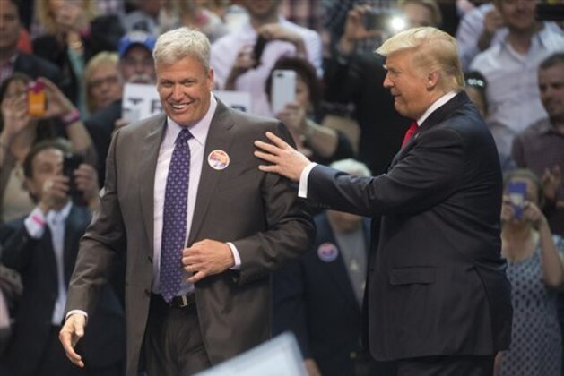 Buffalo Bills head coach Rex Ryan, left, shoes the stage with Republican presidential candidate Donald Trump, right, after introducing him during a campaign stop at the First Niagara Center, Monday, April 18, 2016, in Buffalo, N.Y. (AP Photo/John Minchillo)