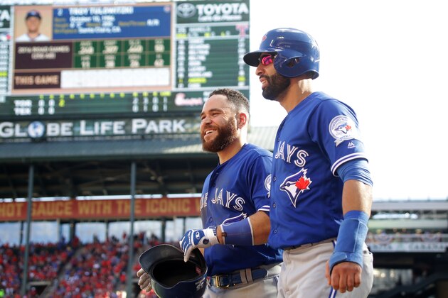 ARLINGTON, TX - OCTOBER 06:  Russell Martin #55 and Jose Bautista #19 of the Toronto Blue Jays celebrate after scoring a run off of Troy Tulowitzki #2 RBI triple to right field against Cole Hamels #35 of the Texas Rangers during the third inning in game one of the American League Divison Series at Globe Life Park in Arlington on October 6, 2016 in Arlington, Texas.  (Photo by Ronald Martinez/Getty Images)
