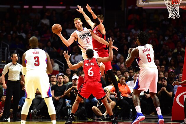 LOS ANGELES, CA - OCTOBER 05:  Blake Griffin #32 of the Los Angeles Clippers passes as he is guarded by Jonas Valanciunas #17 and Cory Joseph #6 of the Toronto Raptors during a preseason game at Staples Center on October 5, 2016 in Los Angeles, California.  NOTE TO USER: User expressly acknowledges and agrees that, by downloading and or using this photograph, User is consenting to the terms and conditions of the Getty Images License Agreement.  (Photo by Harry How/Getty Images)