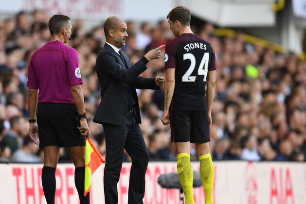 LONDON, ENGLAND - OCTOBER 02:  Josep Guardiola, Manager of Manchester City (L) speaks to John Stones of Manchester City (R) during the Premier League match between Tottenham Hotspur and Manchester City at White Hart Lane on October 2, 2016 in London, England.  (Photo by Shaun Botterill/Getty Images)