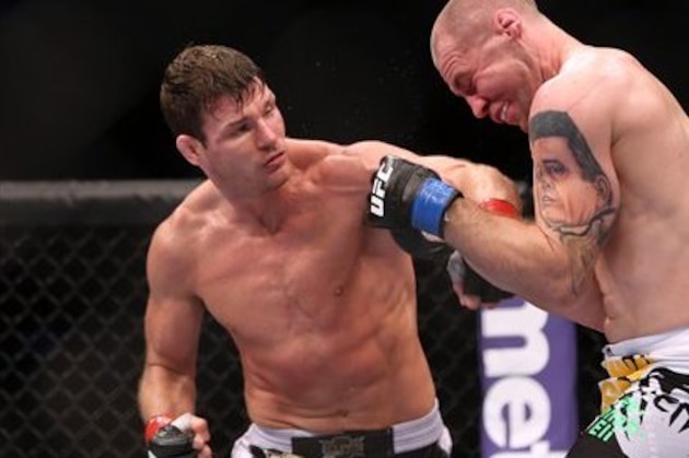 Michael Bisping, left, in action against Alan Belcher during their UFC 159 Mixed Martial Arts middleweight bout in Newark, NJ, Saturday, April 27,2013.  Bisping won via 3-round technical decision after an accidental eye poke. (AP Photo/Gregory Payan)