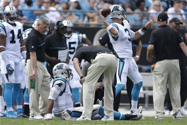 Carolina Panthers' Derek Anderson (3) warms up as trainers attend to Cam Newton (1) in the first half of an NFL football game against the Minnesota Vikings in Charlotte, N.C., Sunday, Sept. 25, 2016. (AP Photo/Bob Leverone)