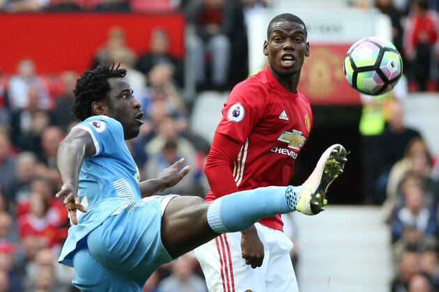 Manchester United's French midfielder Paul Pogba (R) looks on as Stoke City's Ivorian striker Wilfried Bony controls the ball during the English Premier League football match between Manchester United and Stoke City at Old Trafford in Manchester, north west England, on October 2, 2016. / AFP / Scott Heppell / RESTRICTED TO EDITORIAL USE. No use with unauthorized audio, video, data, fixture lists, club/league logos or 'live' services. Online in-match use limited to 75 images, no video emulation. No use in betting, games or single club/league/player publications.  /         (Photo credit should read SCOTT HEPPELL/AFP/Getty Images)