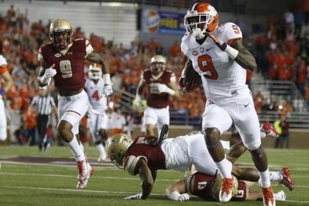 Clemson running back Wayne Gallman (9) gets away from Boston College defensive back Kamrin Moore (5) and linebacker Connor Strachan (13) on a touchdown run during the first quarter of an NCAA college football game in Boston, Friday, Oct. 7, 2016. (AP Photo/Michael Dwyer)