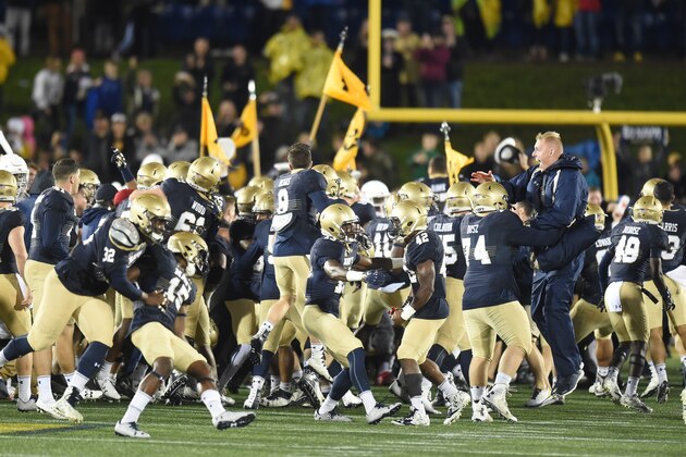 ANNAPOLIS, MD - OCTOBER 08:  Navy Midshipmen fans run on the field after a football game against the Houston Cougars at Navy-Marines Memorial Stadium on October 8, 2016 in Annapolis, Maryland.   The Midshipman won 46-40. (Photo by Mitchell Layton/Getty Images)