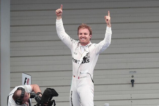 Mercedes AMG Petronas F1 Team's German driver Nico Rosberg celebrates after winning the Formula One Japanese Grand Prix race in Suzuka on October 7, 2016. / AFP / BEHROUZ MEHRI        (Photo credit should read BEHROUZ MEHRI/AFP/Getty Images)