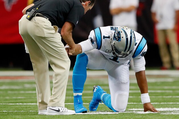 ATLANTA, GA - OCTOBER 02:  Cam Newton #1 of the Carolina Panthers is worked on by a trainer during a timeout after taking a hit on a rush against the Atlanta Falcons at Georgia Dome on October 2, 2016 in Atlanta, Georgia.  (Photo by Kevin C. Cox/Getty Images)
