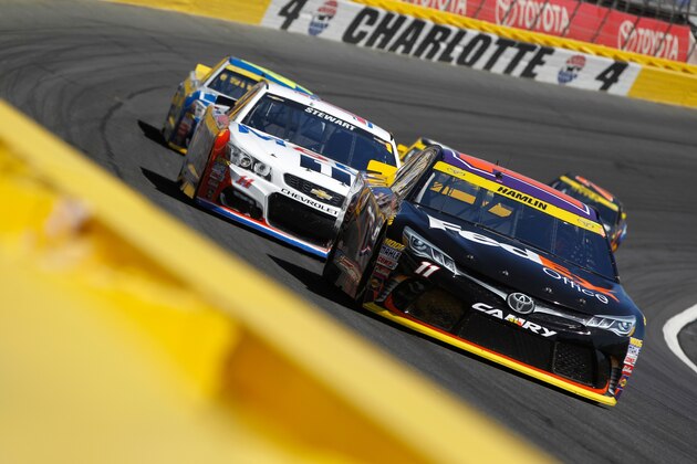 CHARLOTTE, NC - OCTOBER 09:  Denny Hamlin, driver of the #11 FedEx Office Toyota, leads a pack of cars during the NASCAR Sprint Cup Series Bank of America 500 at Charlotte Motor Speedway on October 9, 2016 in Charlotte, North Carolina.  (Photo by Brian Lawdermilk/Getty Images)
