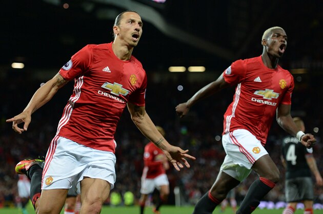 Manchester United's Swedish striker Zlatan Ibrahimovic (L) celebrates with Manchester United's French midfielder Paul Pogba after scoring their second goal from the penalty spot during the English Premier League football match between Manchester United and Southampton at Old Trafford in Manchester, north west England, on August 19, 2016. / AFP / Oli SCARFF / RESTRICTED TO EDITORIAL USE. No use with unauthorized audio, video, data, fixture lists, club/league logos or 'live' services. Online in-match use limited to 75 images, no video emulation. No use in betting, games or single club/league/player publications.  /         (Photo credit should read OLI SCARFF/AFP/Getty Images)