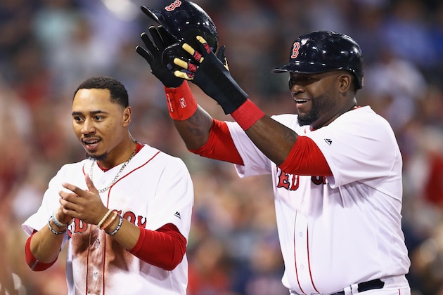 BOSTON, MA - SEPTEMBER 12:  David Ortiz #34 of the Boston Red Sox takes off Mookie Betts' #50 helmet after they both scored against the Baltimore Orioles during the first inning at Fenway Park on September 12, 2016 in Boston, Massachusetts.  (Photo by Maddie Meyer/Getty Images)