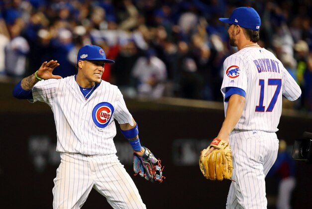 Oct 7, 2016; Chicago, IL, USA; Chicago Cubs second baseman Javier Baez (9) celebrates their win over the San Francisco Giants with third baseman Kris Bryant (17) during game one of the 2016 NLDS playoff baseball series at Wrigley Field. Mandatory Credit: Jerry Lai-USA TODAY Sports