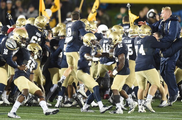 ANNAPOLIS, MD - OCTOBER 08:  Navy Midshipmen fans run on the field after a football game against the Houston Cougars at Navy-Marines Memorial Stadium on October 8, 2016 in Annapolis, Maryland.   The Midshipman won 46-40. (Photo by Mitchell Layton/Getty Images)
