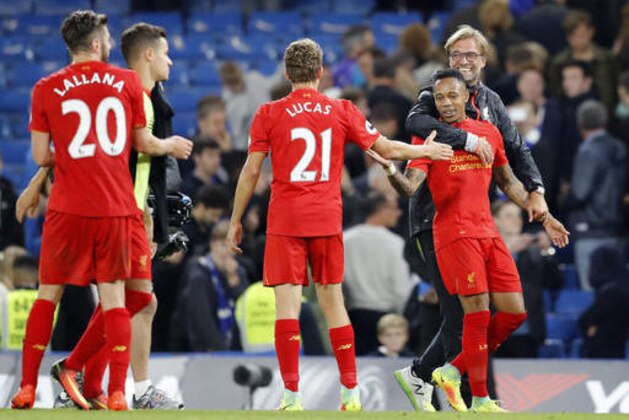 Liverpool's head coach Juergen Klopp, right, celebrates with the players at the end of the English Premier League soccer match between Chelsea and Liverpool at Stamford Bridge stadium in London, Friday, Sept. 16, 2016. Liverpool won 2-1. (AP Photo/Frank Augstein)