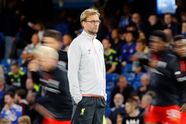 In this picture taken with a slow shutter speed, Liverpool's head coach Juergen Klopp watches the players warm up before the English Premier League soccer match between Chelsea and Liverpool at Stamford Bridge stadium in London, Friday, Sept. 16, 2016. (AP Photo/Frank Augstein)