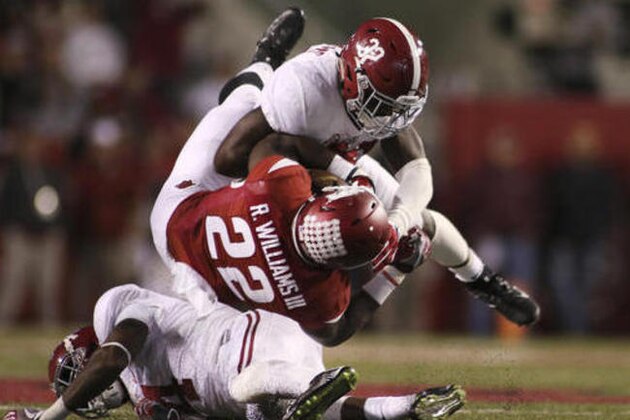 Arkansas' Rawleigh Williams III (22) is tackled by Alabama's Eddie Jackson and Rashaan Evans (32) during the fourth quarter of an NCAA college football game Saturday, Oct. 8, 2016, in Fayetteville, Ark. Alabama won 49-30. (AP Photo/Samantha Baker)