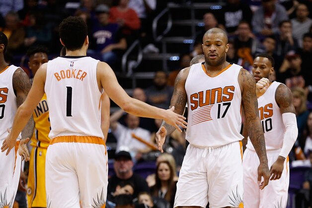 PHOENIX, AZ - JANUARY 19:  P.J. Tucker #17 of the Phoenix Suns high-fives Devin Booker #1 during the second half of the NBA game against the Indiana Pacers at Talking Stick Resort Arena on January 19, 2016 in Phoenix, Arizona.  NOTE TO USER: User expressly acknowledges and agrees that, by downloading and or using this photograph, User is consenting to the terms and conditions of the Getty Images License Agreement.  (Photo by Christian Petersen/Getty Images)