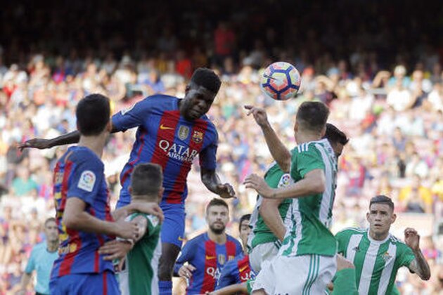 FC Barcelona's Samuel Umtiti, center left, heads for the ball during a Spanish La Liga soccer match between FC Barcelona and Betis at the Camp Nou in Barcelona, Spain, Saturday, Aug. 20, 2016. (AP Photo/Manu Fernandez)
